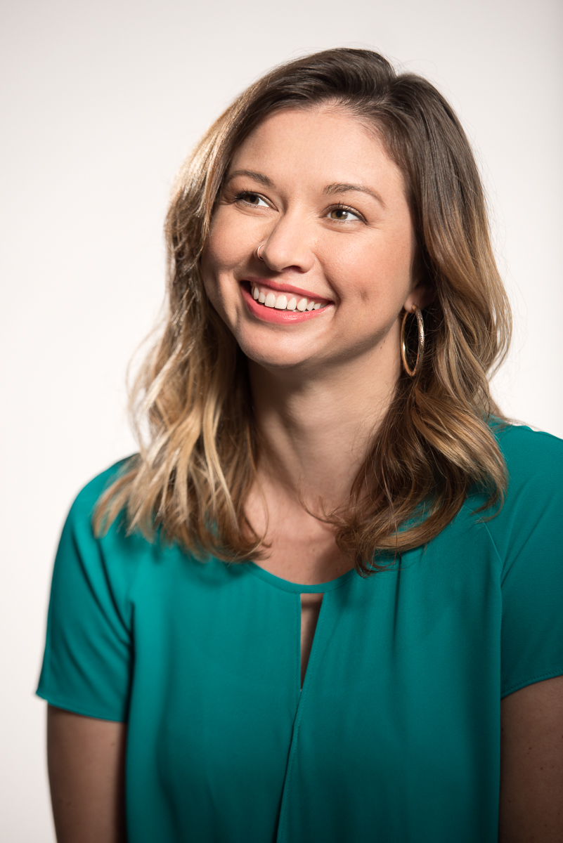Studio portrait of woman smiling looking off camera