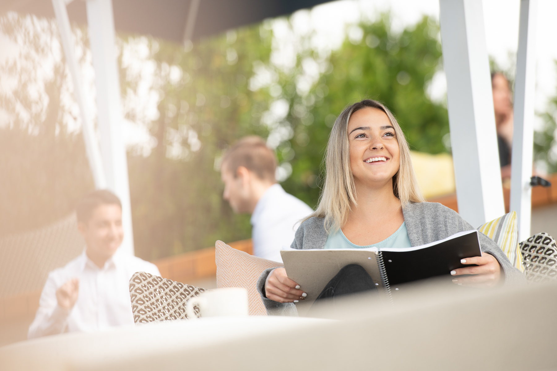 Young woman smiles working outdoors in Southern California