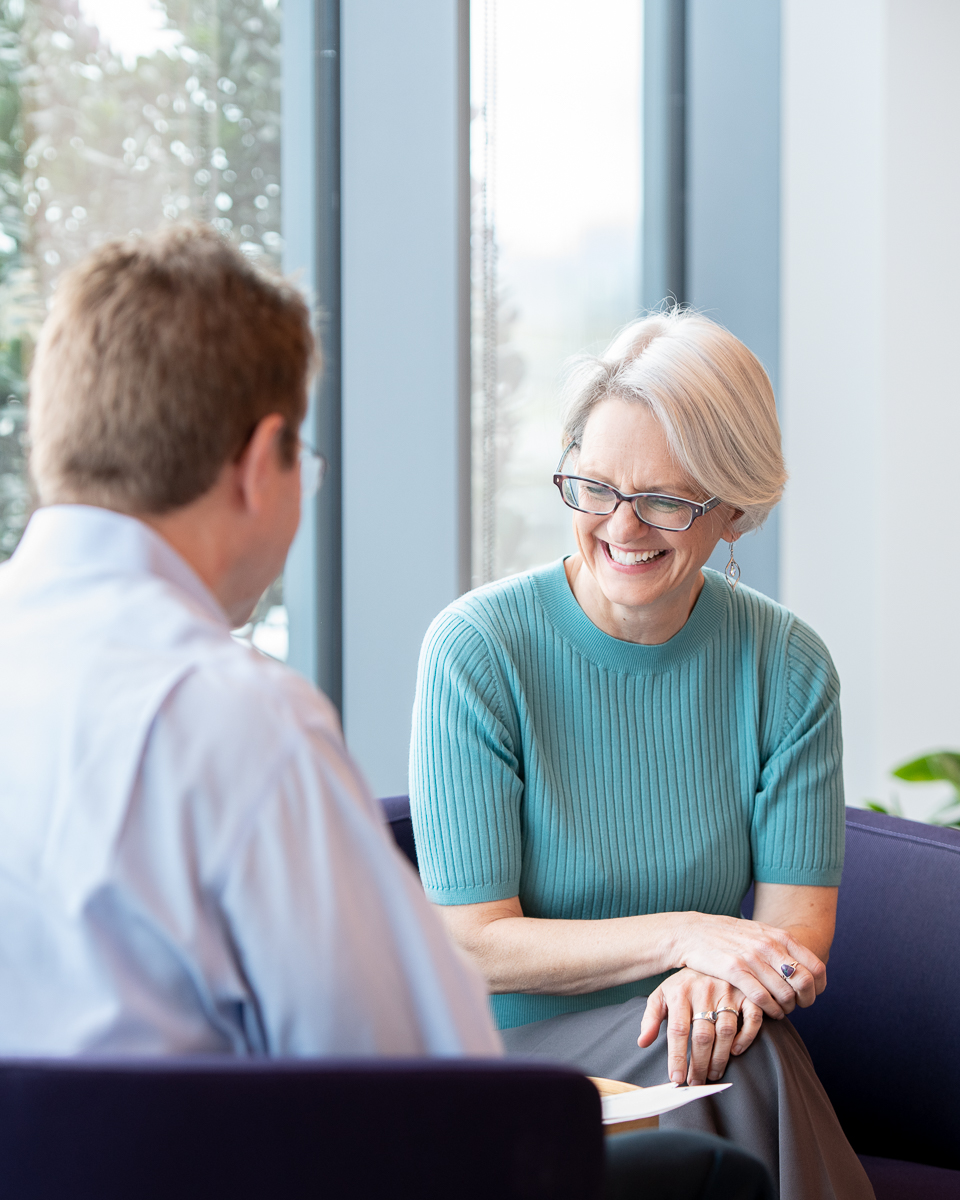 Woman laughs during meeting at Mirati Therapeutics