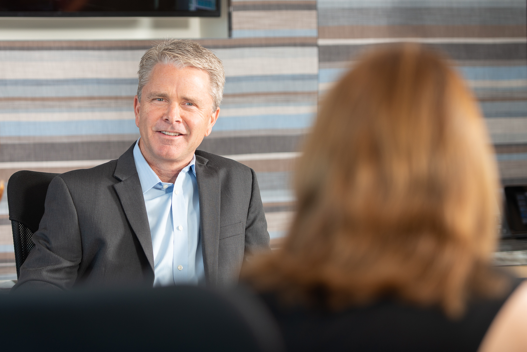 Corporate Attorney smiles in meeting with client