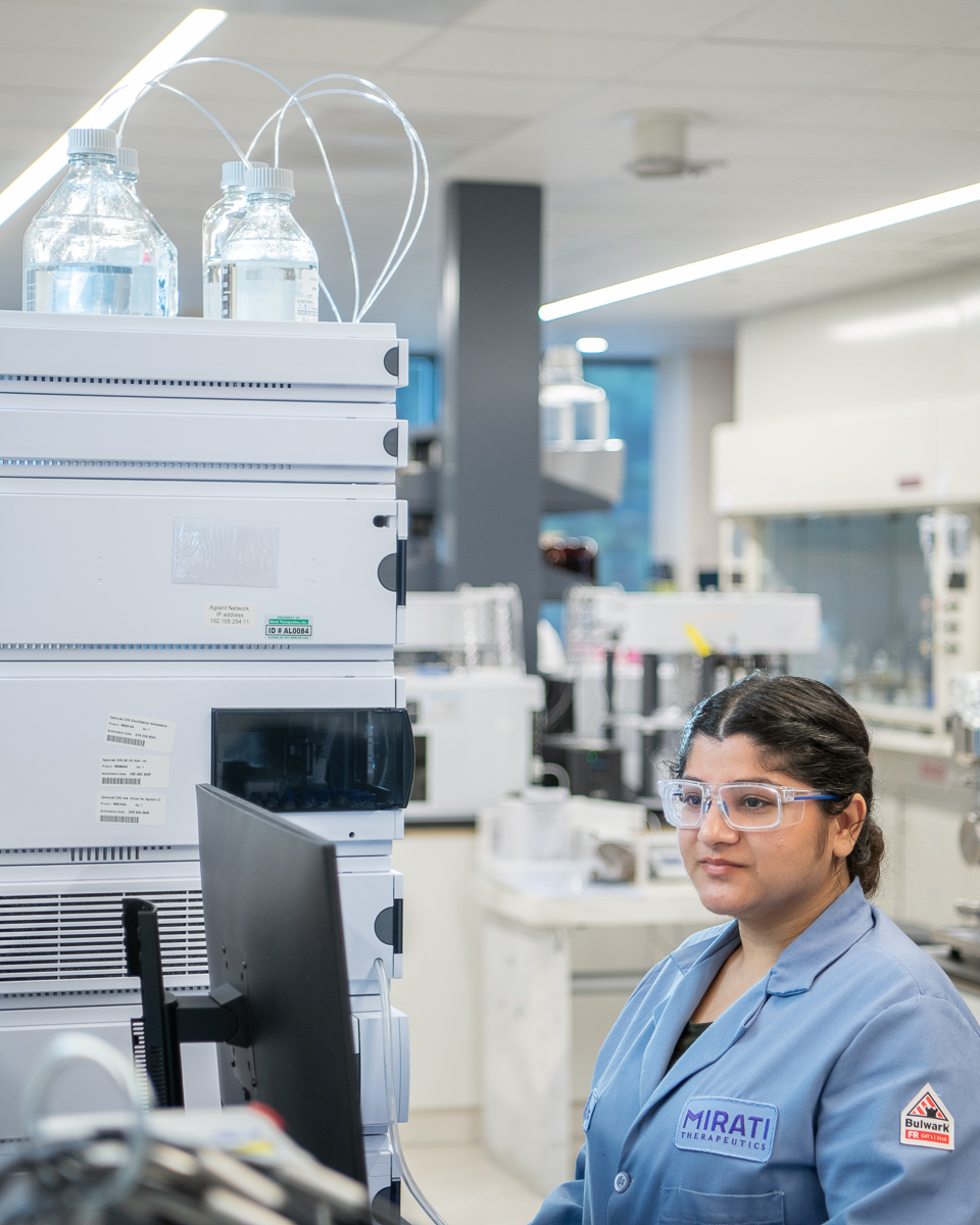 Female scientist reads experiment data in her biotech lab