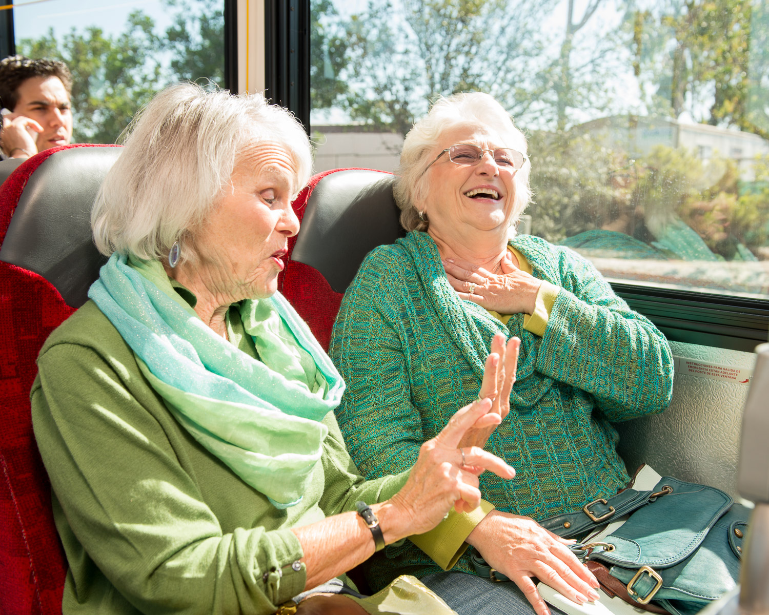 Senior women share a laugh on the bus