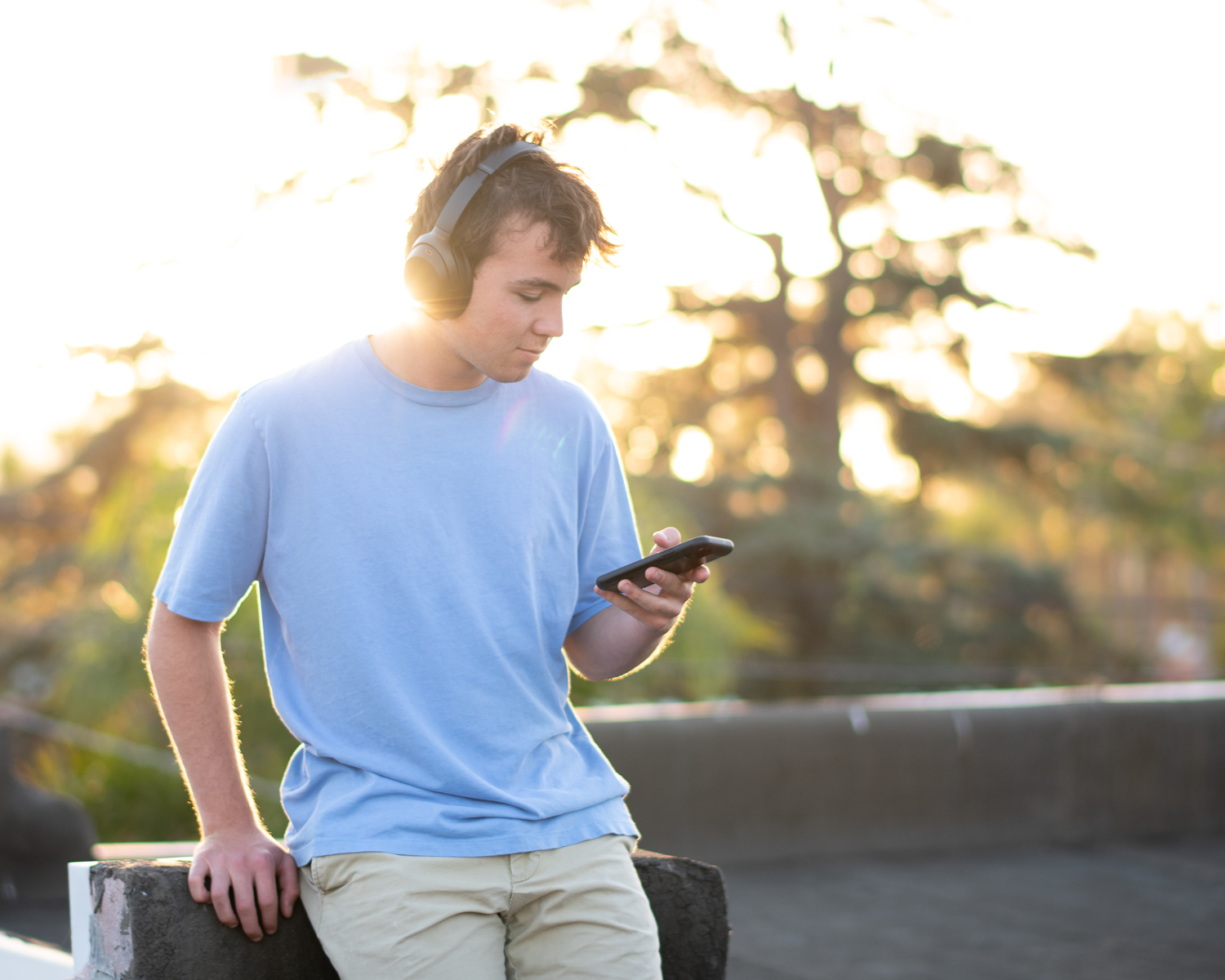 teenage male listens to music on headphones