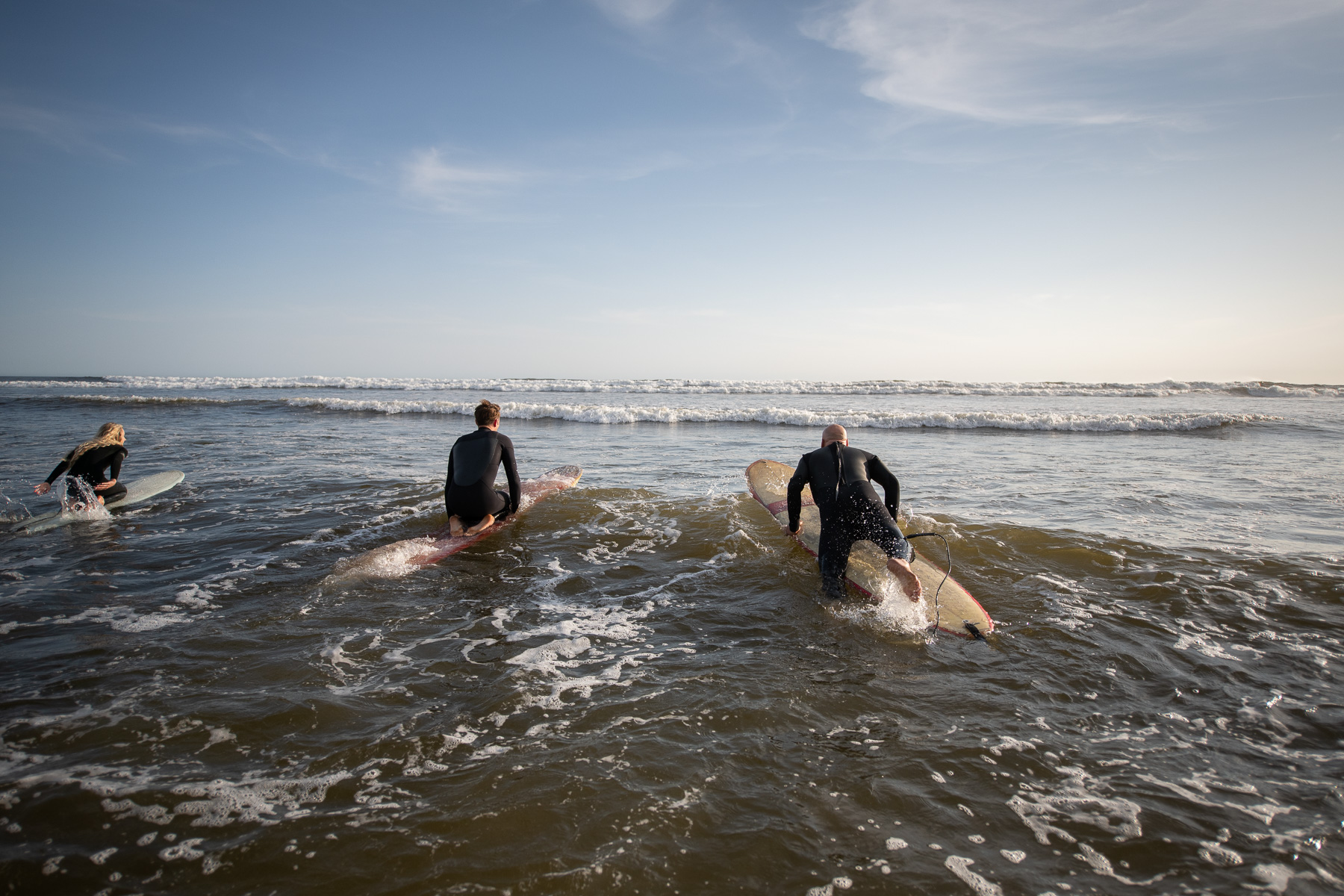 Family paddles into the surf